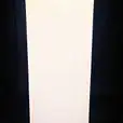 A glowing white cube sitting on a black background.