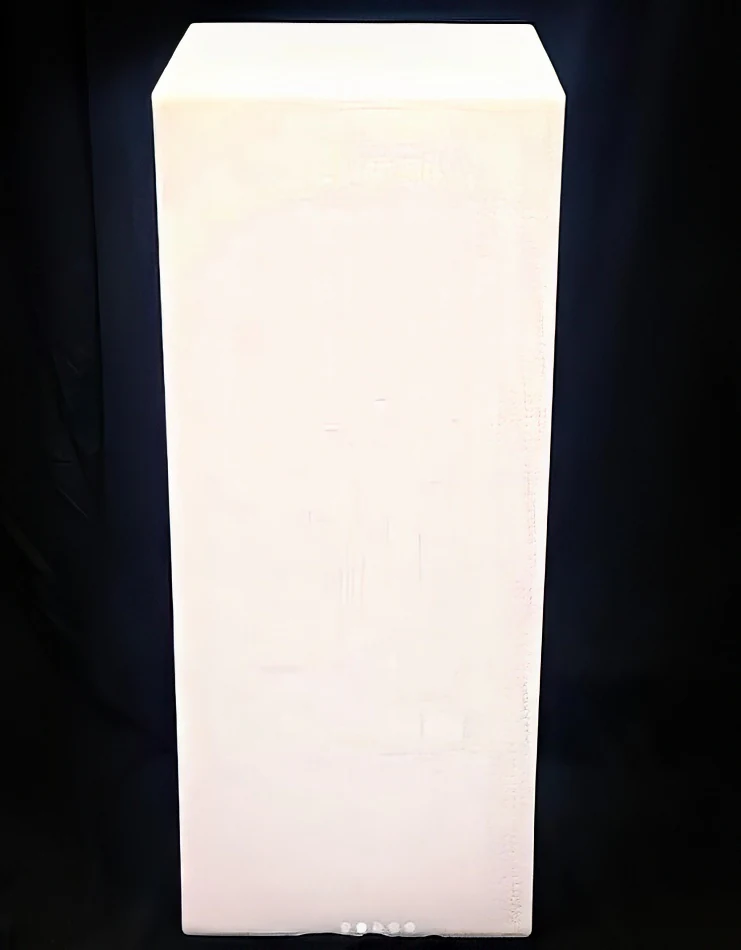 A glowing white cube sitting on a black background.