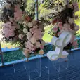 Clear acrylic plinths displaying florals at a styled event