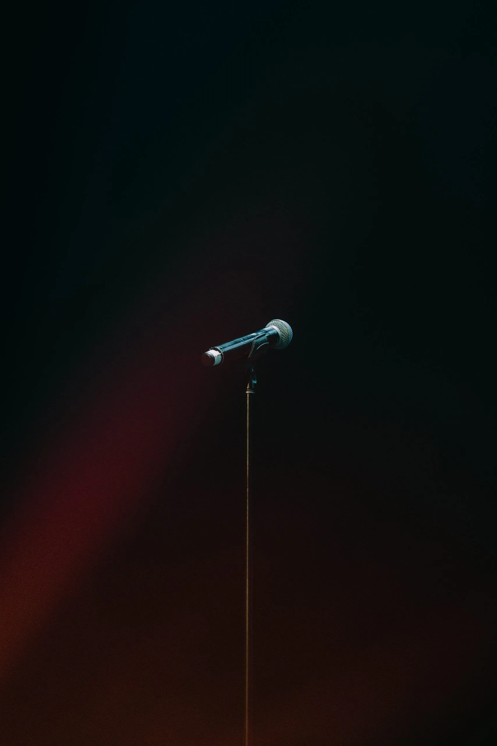 A wireless microphone in front of a dark background.