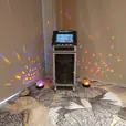A karaoke machine with colorful lights, available for Jukebox Hire Only in a room.