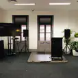 A room with a tv and speakers for an immersive audiovisual experience.