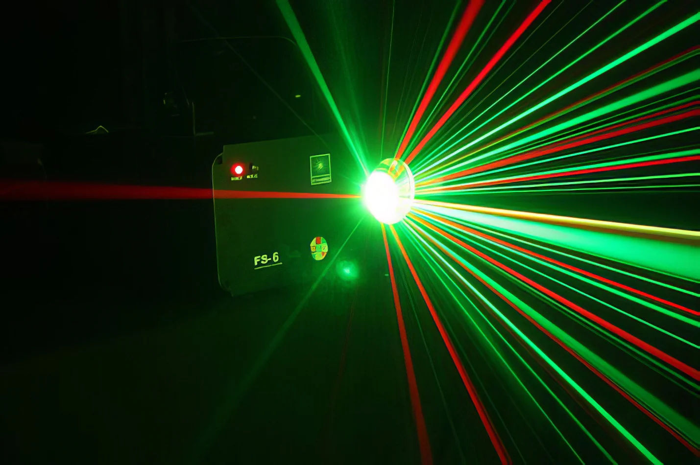 A multi-colored laser light in a dark room.