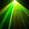 An image of a green laser light cutting through the darkness.