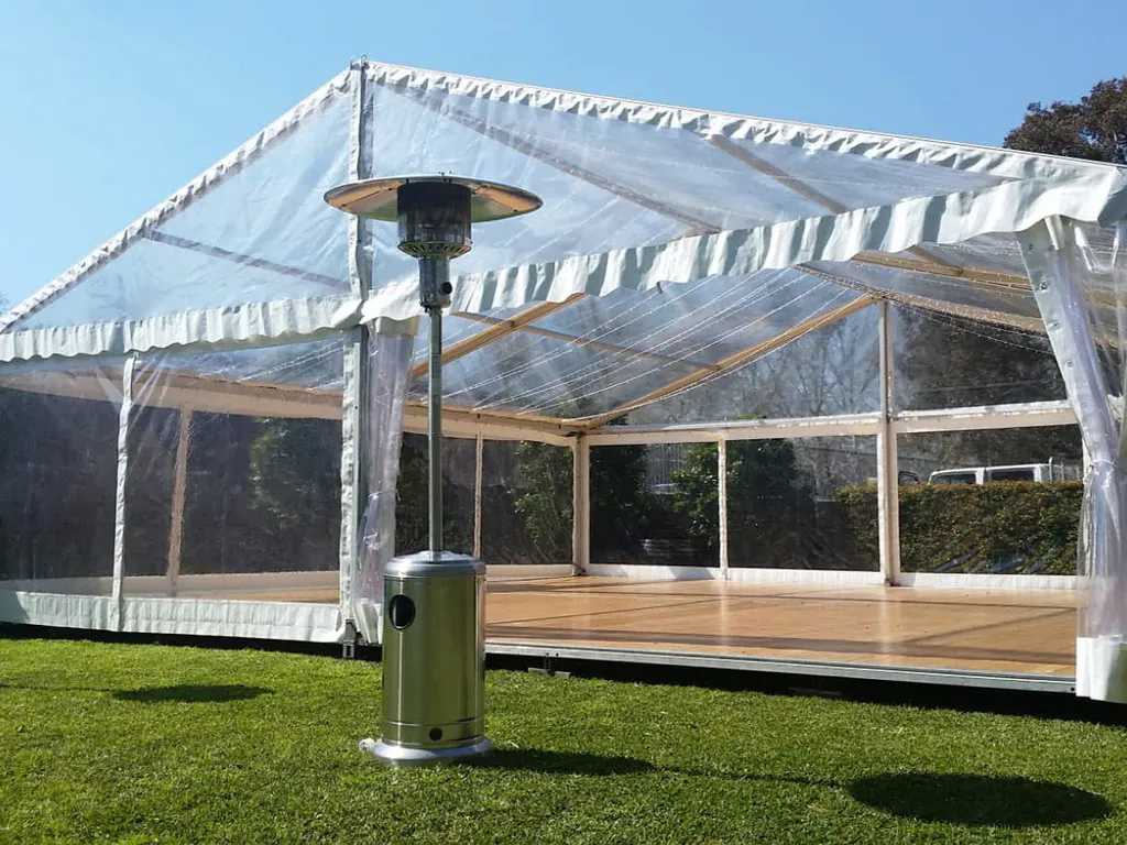 A white tent with a heater on the grass, featuring Pkg 1 - 1 x Mushroom Heater w/ Gas Bottle.