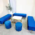 Navy blue ottoman stools next to an ottoman lounge