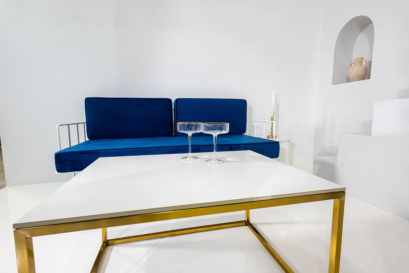 Navy blue wire sofa lounge behind a coffee table