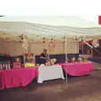 A pink tablecloth covers a pink table.