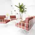 Our white wire armchair with pink velvet cushions