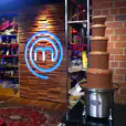 Package 4 - A large commercial chocolate fountain displayed in front of a sign that says masterchef.