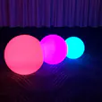Three vibrant led balls on a carpet.