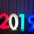 The glowing numbers 2019 are lit up in different colors.