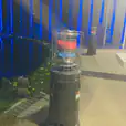 Two gas heaters warming an area in front of a pool at night.