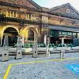 A brick building entrance with a wheelchair ramp available for hire.