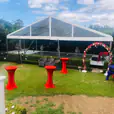 A party tent set up in a backyard using our red Lycra Socks
