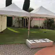 A 3mx3m pop up marquee with walls set up in a backyard.