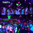 A group of people dressed up in UV Black Light Hire at a party.