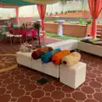 A party patio set up with white ottoman cube hire.