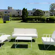 White sofa lounges on a beautiful green lawn