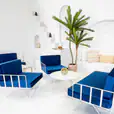 White wire lounge chairs with blue velvet cushions for hire