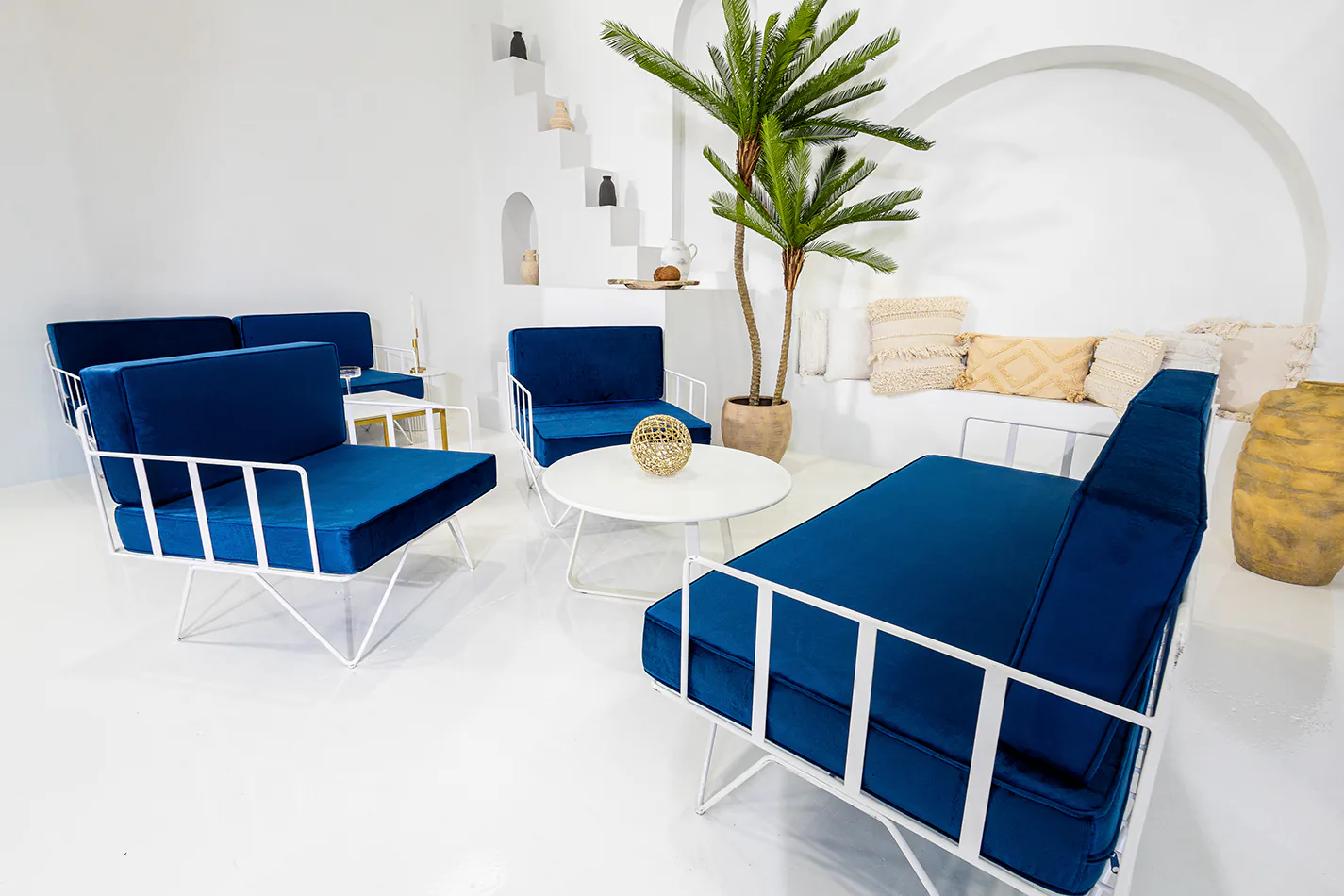 White wire lounge chairs with blue velvet cushions