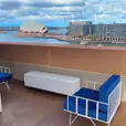 White wire lounge chairs with Sydney Harbour in the background