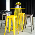 Yellow wire cocktail table with Tolix stools