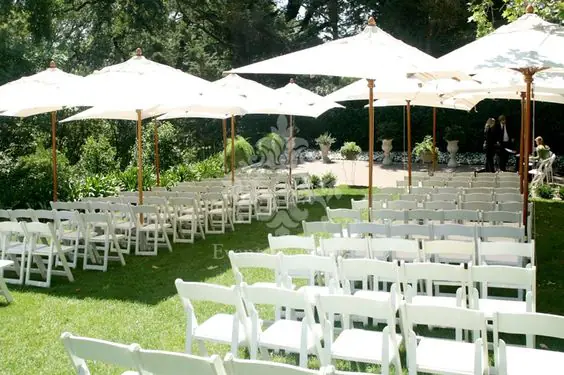 Guests seated under shade during outdoor wedding