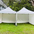Two 3mx3m Pop Up Marquees with Walls on a grassy area.