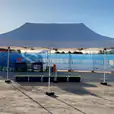 A 3mx6m pop up marquee with a white roof, set up in front of a construction site.
