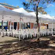 A 3mx6m white tent, also known as a pop-up marquee with a white roof, set up in front of a building.