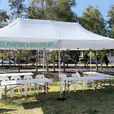 The park is adorned with a 3mx6m white tent, filled with tables and chairs for gatherings.