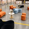 Black and sky blue Apollo daybeds with Sienna ottomans, gold bollards and an Atlas coffee table at an event