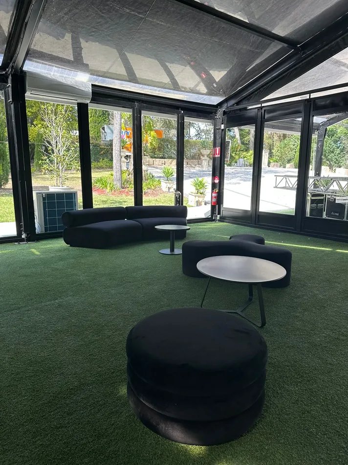Large black velvet Apollo ottomans used as lounge seating at an event