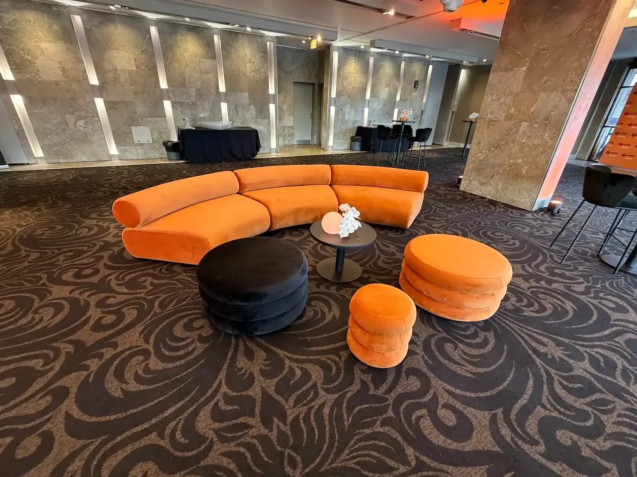 Small black velvet Apollo ottomans used as flexible event seating