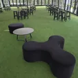 Apollo tripod day bed in black velvet styled with ottomans at an event