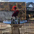 Gold Avery bar stools arranged around a high bar at a wedding cocktail reception