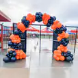 A large orange and black balloon arch