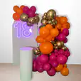 A colourful balloon garland with a neon sign made for hiring