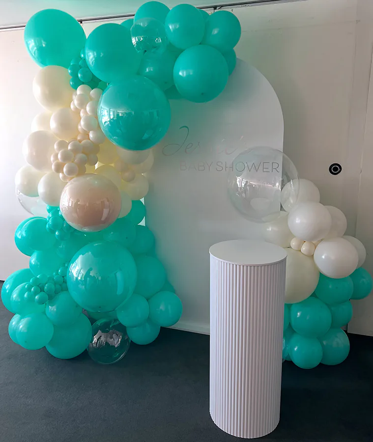 A balloon garland with aqua and white balloons