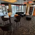 Black Apollo lounge furniture with Sienna ottomans and black Atlas coffee tables in a conference lounge