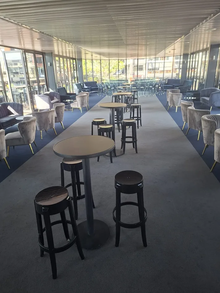 Black Atlas bar table with black Ghost stools in a modern event setting