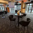 Black Atlas bar table with black velvet bar stools in an event lounge