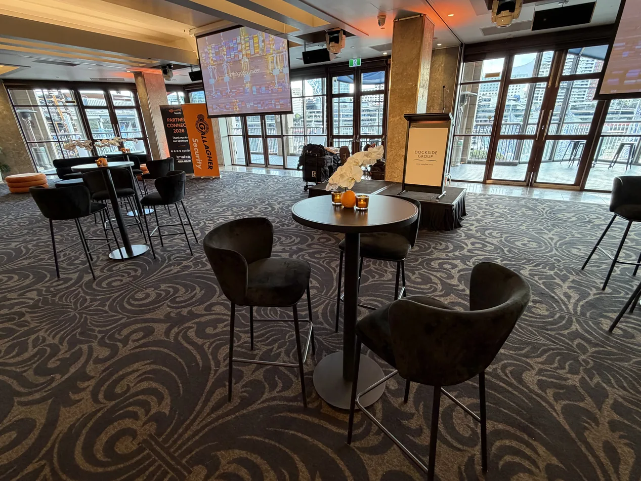 Black Atlas bar table with black velvet bar stools in an event lounge