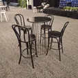 Four black bentwood bar stools with curved back rests arranged around a black wire cocktail table at an indoor sports event