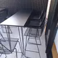 Black hairpin table set up with chairs