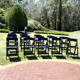 A group of Black Padded Folding Chairs set up in a park for hire.