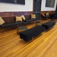 Black velvet ottoman bench in an event lounge setting