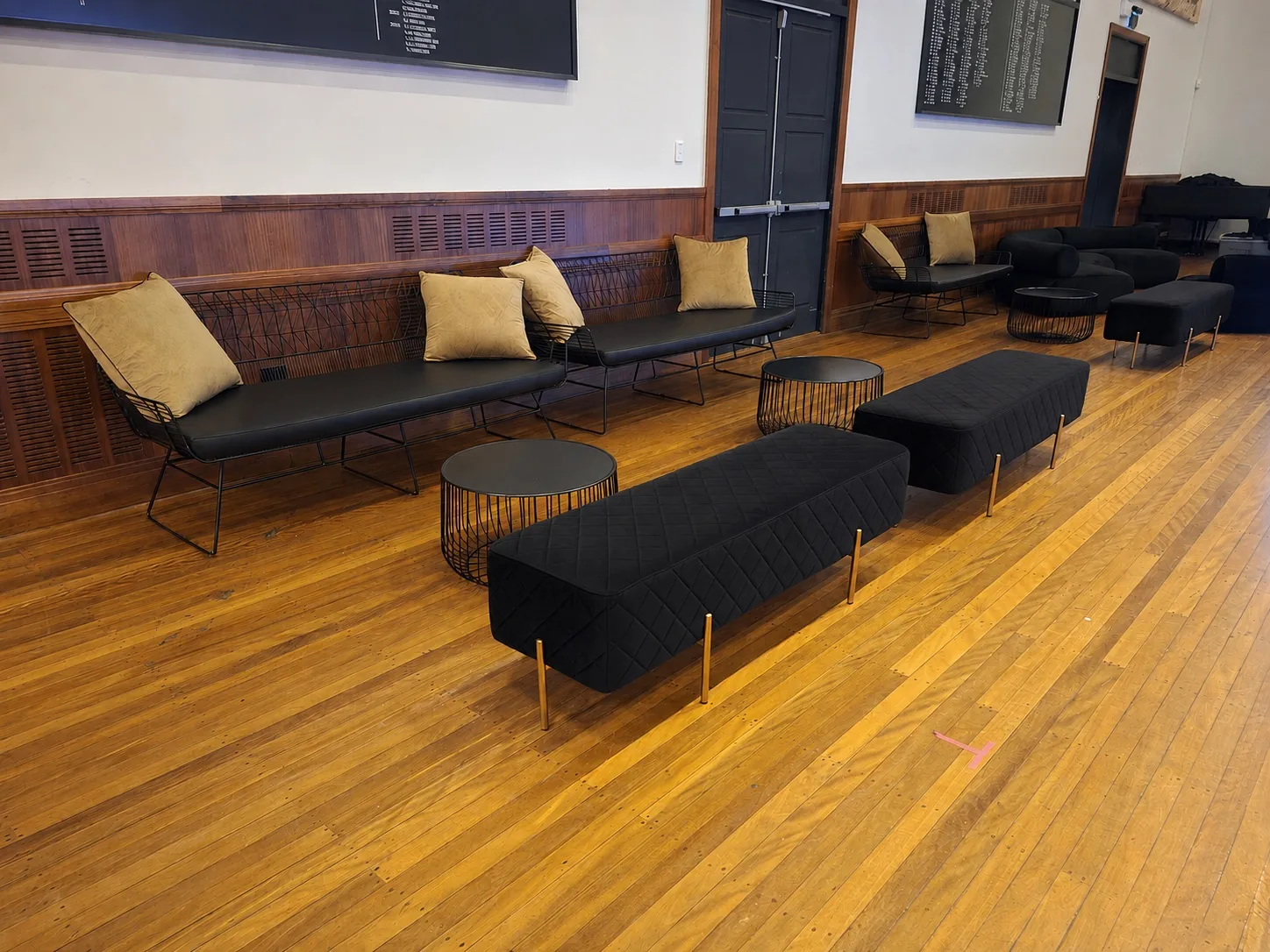 Black velvet ottoman bench in an event lounge setting