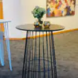 A black metal table with flowers on it.